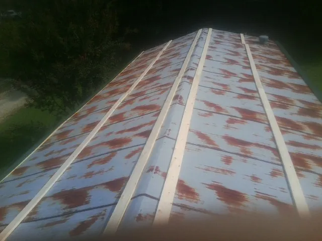 Rusted metal roof panels with new wood purlins before replacement — Storm Damage Roof Repair in Corpus Christi by Roofing Brothers