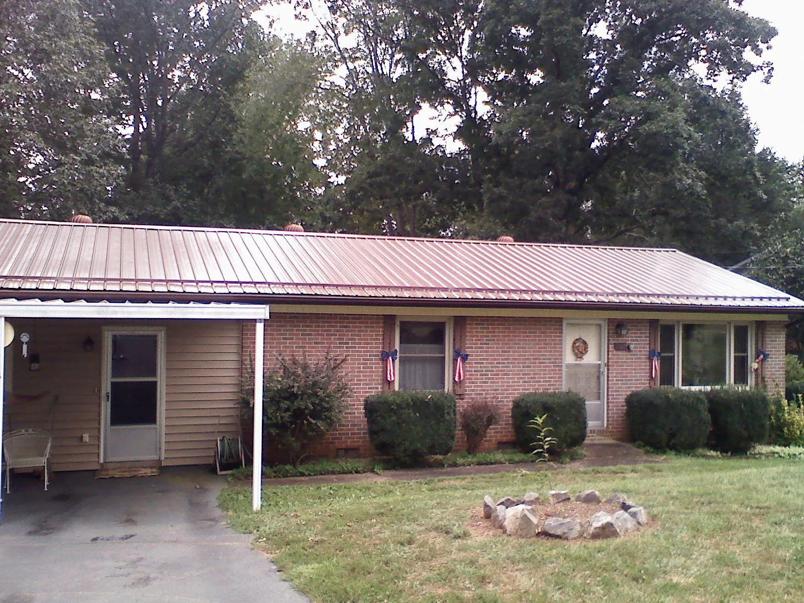 Bronze metal roof and carport on a brick ranch home — Roof Repair work by our crew in Corpus Christi