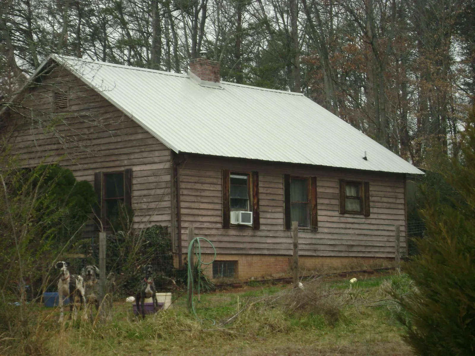 White metal roof on an old wood sided farmhouse, from a Metal Roof Installation job in Corpus Christi